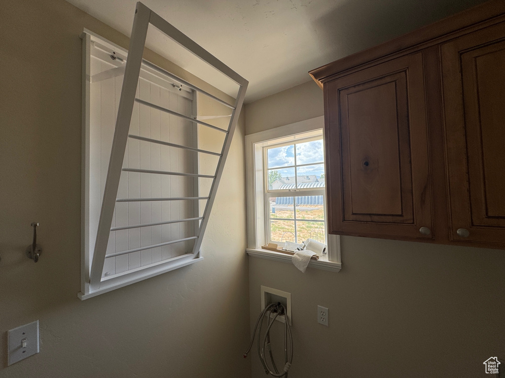Washroom featuring cabinet space and hookup for a washing machine