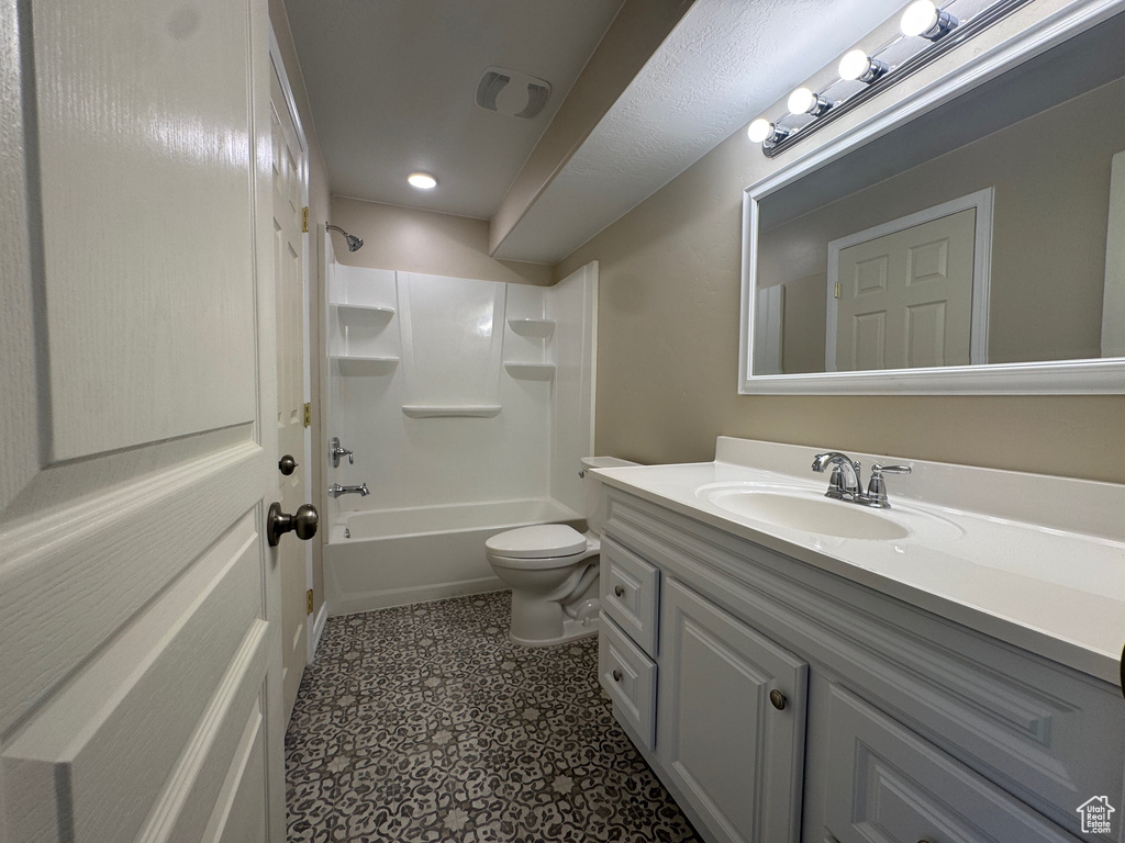 Full bath featuring vanity, shower / washtub combination, tile patterned floors, and recessed lighting