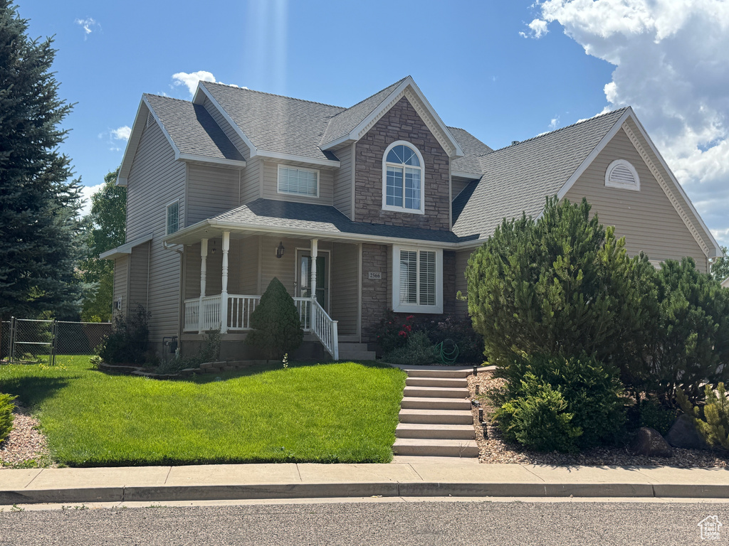View of front of house featuring a porch and stone siding