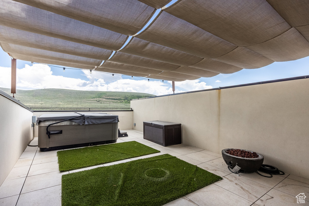 View of patio featuring a hot tub