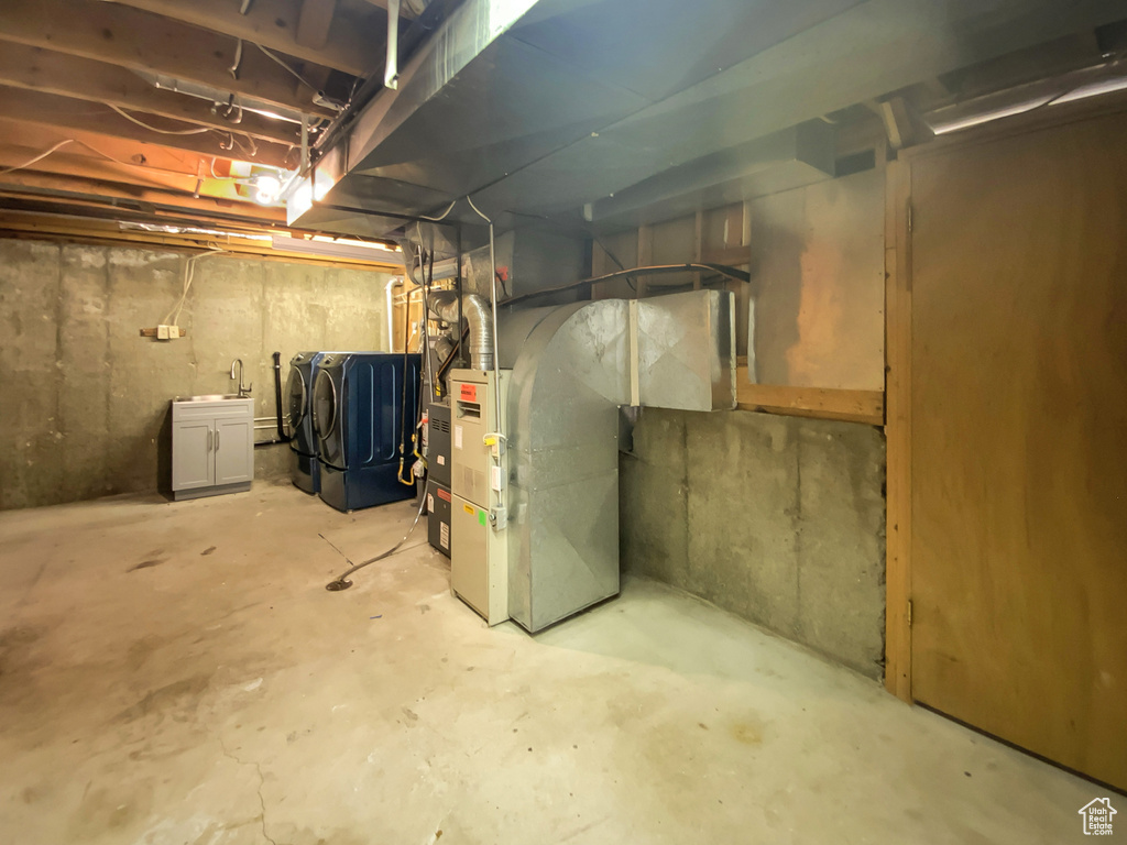 Unfinished basement with separate washer and dryer and heating unit
