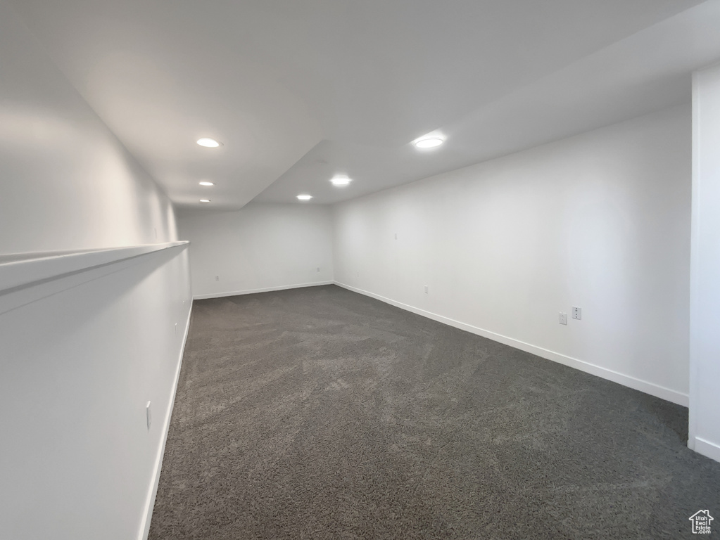 Finished basement with recessed lighting and dark carpet