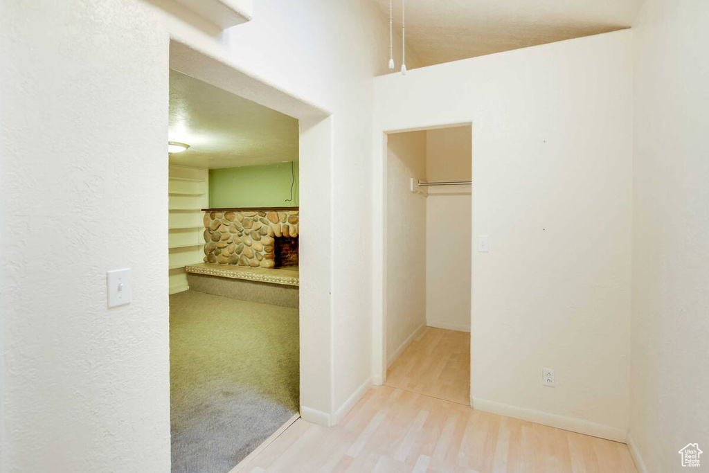 Corridor with wood finished floors and baseboards