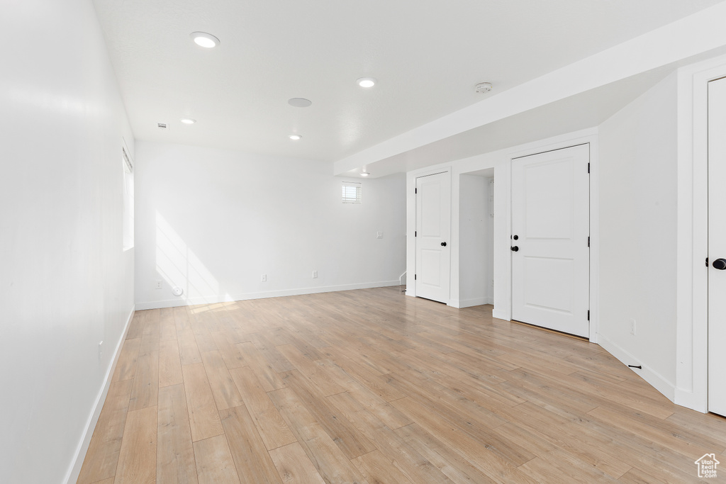 Spare room with light wood finished floors, recessed lighting, and a smoke detector