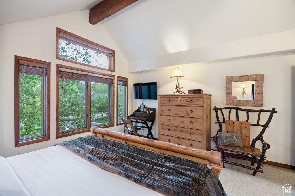 Bedroom featuring beam ceiling, high vaulted ceiling, and carpet flooring