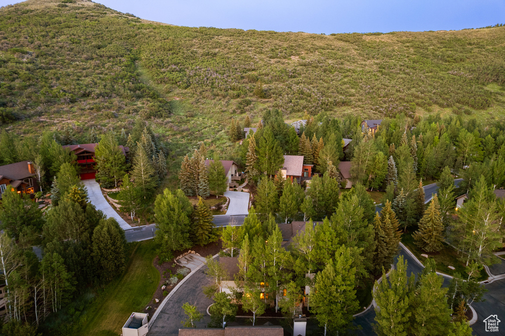 Aerial view of property and surrounding area featuring a forest