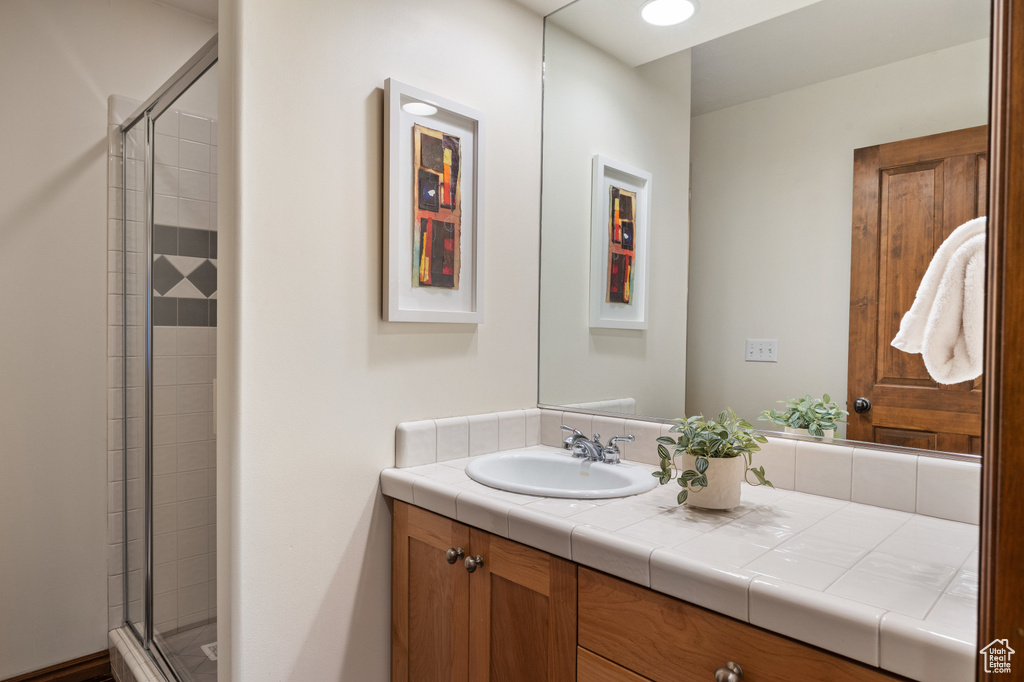 Full bath with vanity and a shower stall