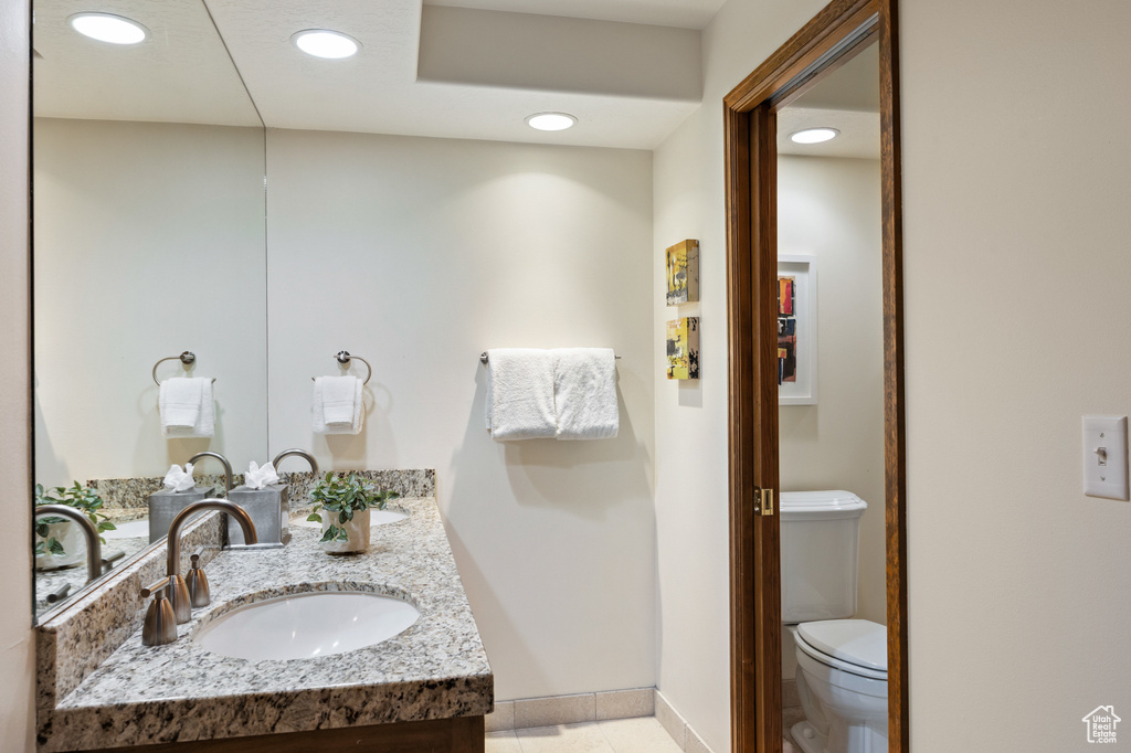 Bathroom featuring double vanity, recessed lighting, and tile patterned flooring