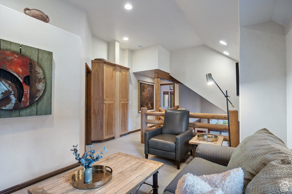 Living room featuring recessed lighting, vaulted ceiling, and light colored carpet