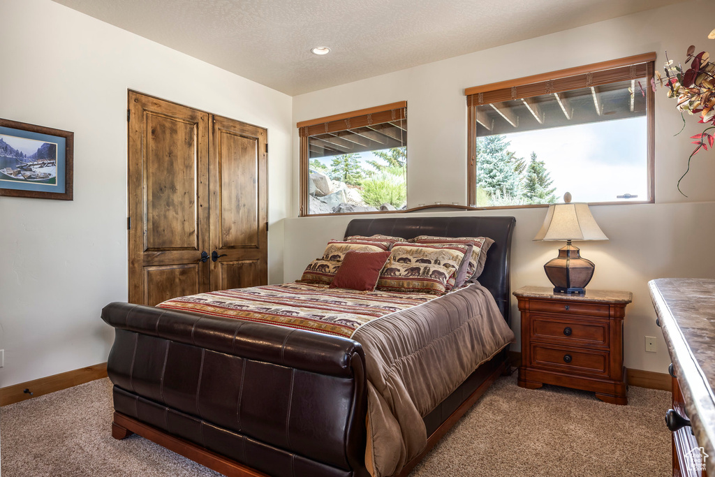 Carpeted bedroom featuring baseboards
