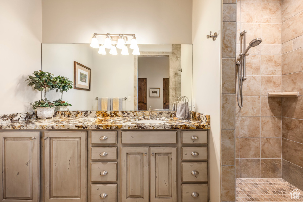 Full bathroom with double vanity and a tile shower