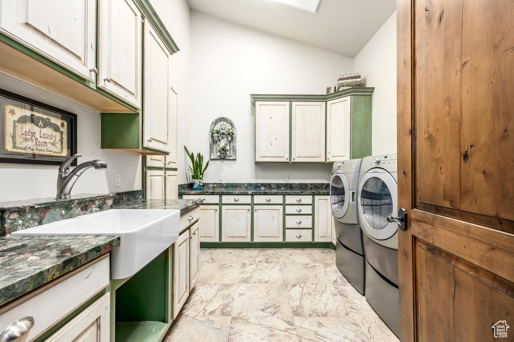 Laundry room featuring cabinet space, independent washer and dryer, and light marble finish floors