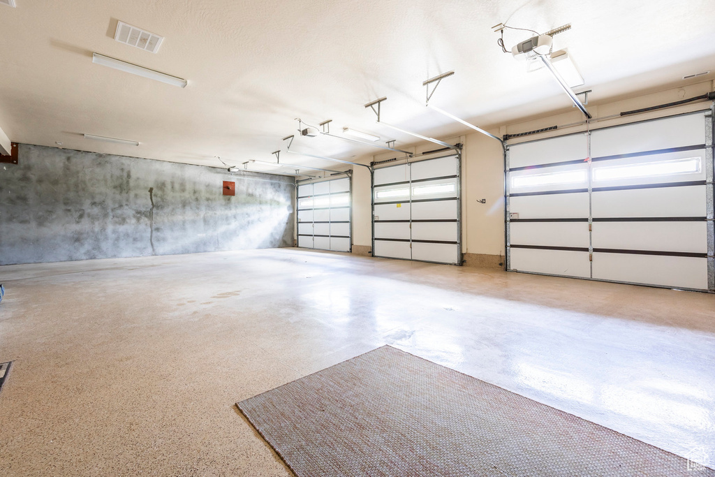 Garage featuring a garage door opener