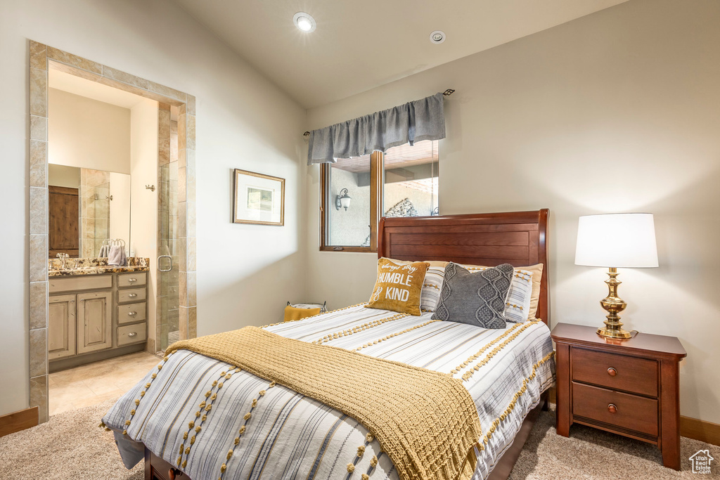Bedroom featuring vaulted ceiling and connected bathroom