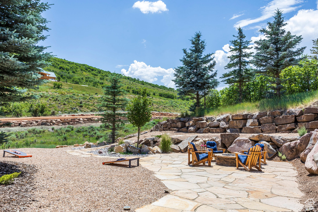 View of patio featuring a fire pit and a mountain view