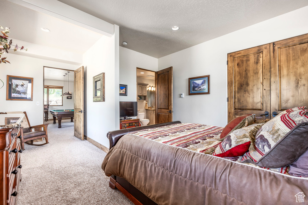 Bedroom featuring light carpet, billiards table, recessed lighting, and a textured ceiling