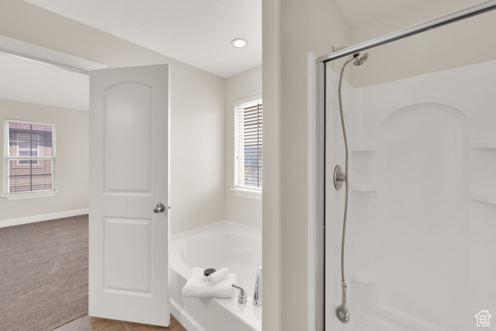 Full bath with a shower stall, a bath, and recessed lighting