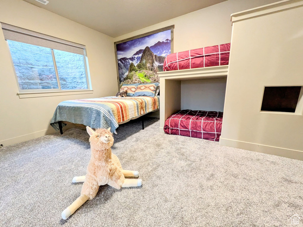 Carpeted bedroom featuring baseboards