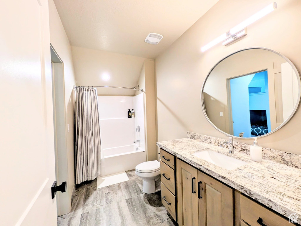 Bathroom with vanity, shower / tub combo with curtain, and wood finished floors