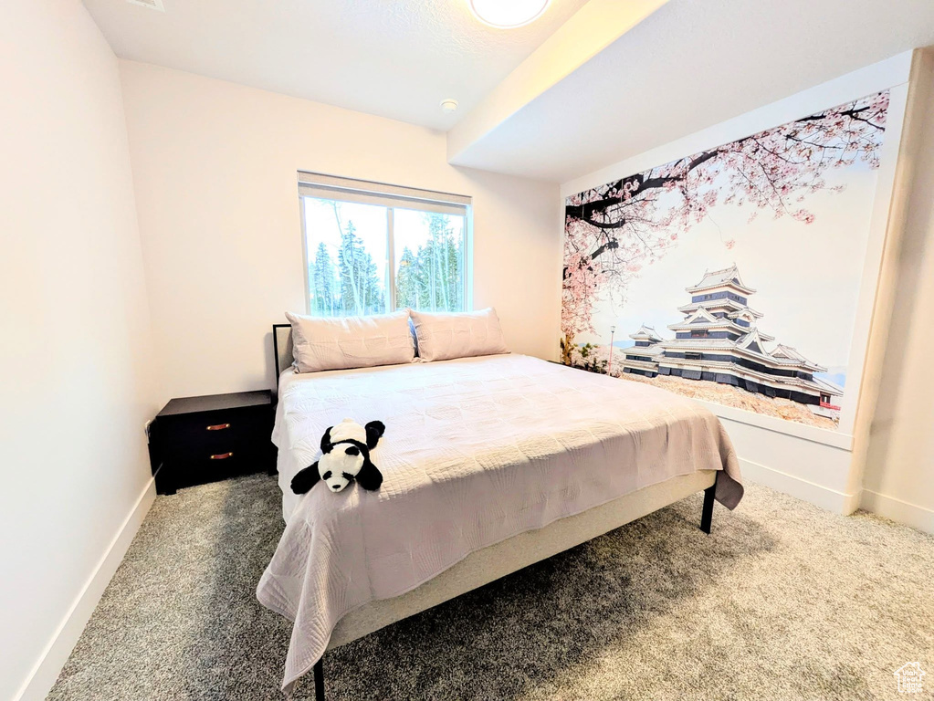 Carpeted bedroom featuring baseboards