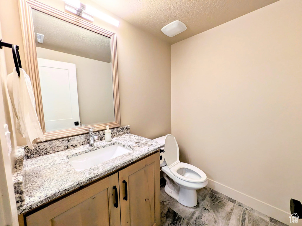 Bathroom featuring vanity and a textured ceiling