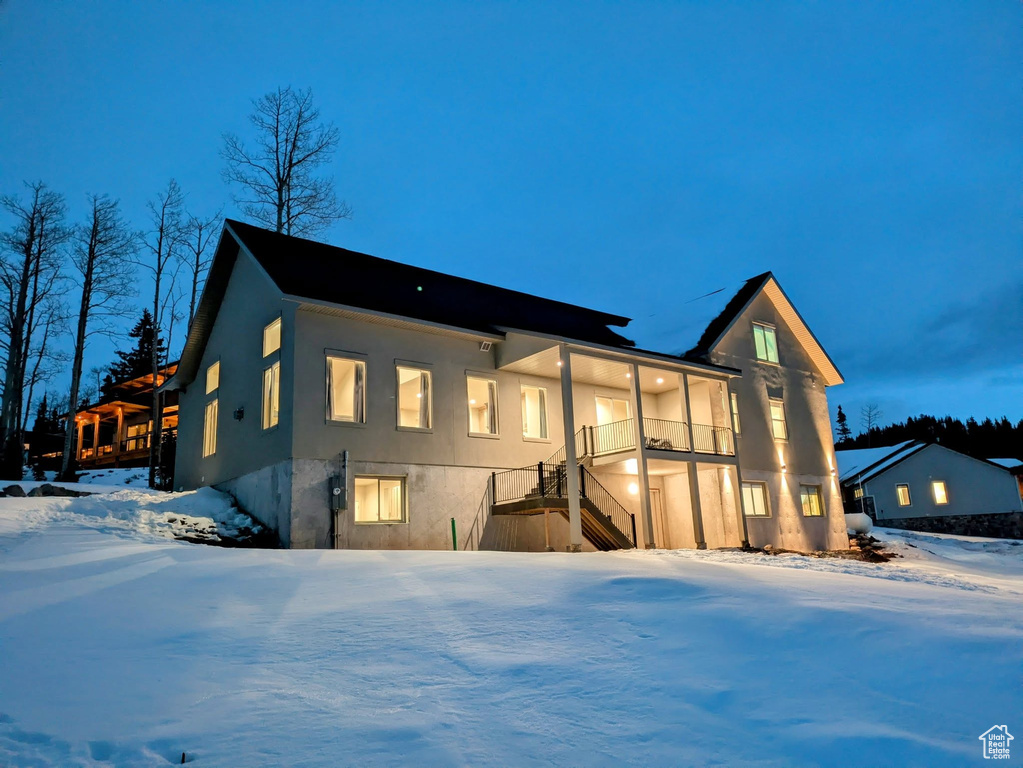 View of front of property with stairway and stucco siding