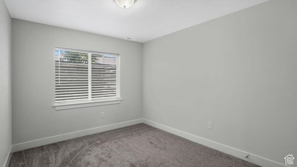 Unfurnished room featuring carpet flooring and baseboards