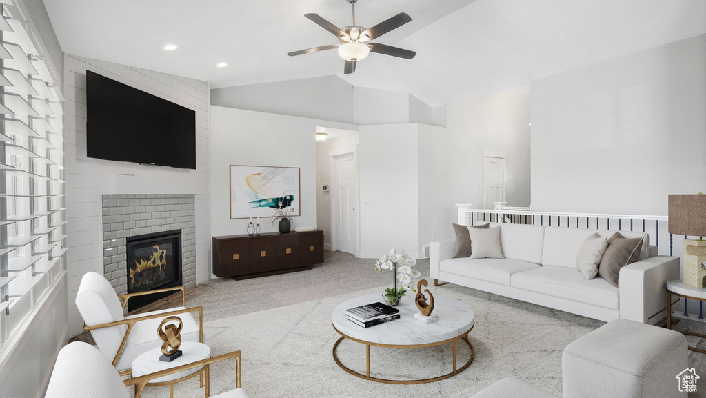 Living room with ceiling fan, lofted ceiling, a fireplace, carpet floors, and recessed lighting