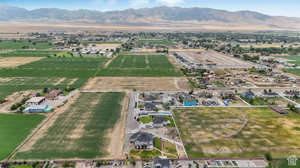 Aerial view of property and surrounding area with rural landscape, mountains, and property parcel outlined