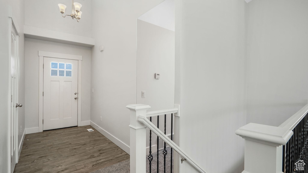 Entrance foyer with a chandelier and wood finished floors
