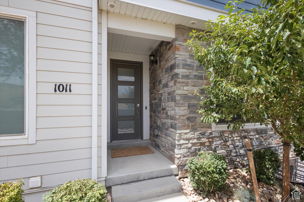 Entrance to property with stone siding