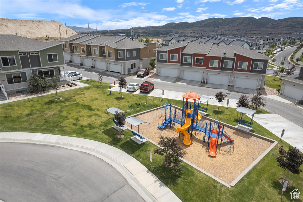 Aerial perspective of suburban area with a mountain backdrop and a community park
