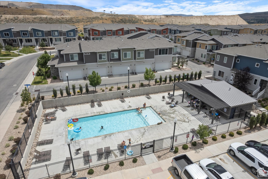 Aerial view of residential area featuring a pool area and mountains