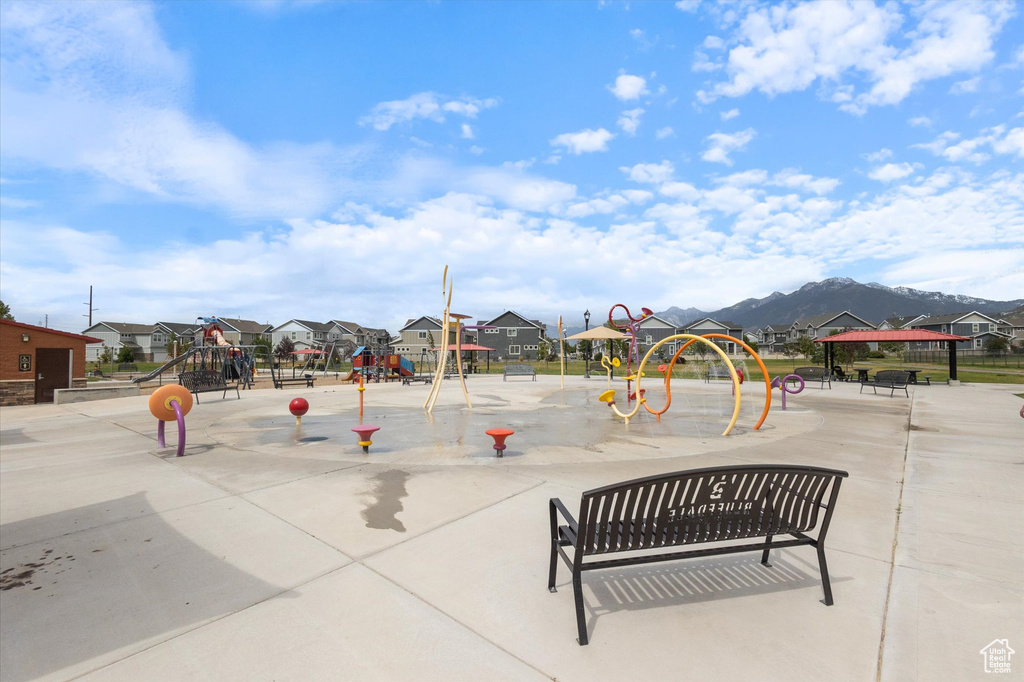 Community playground featuring a residential view and a mountain view