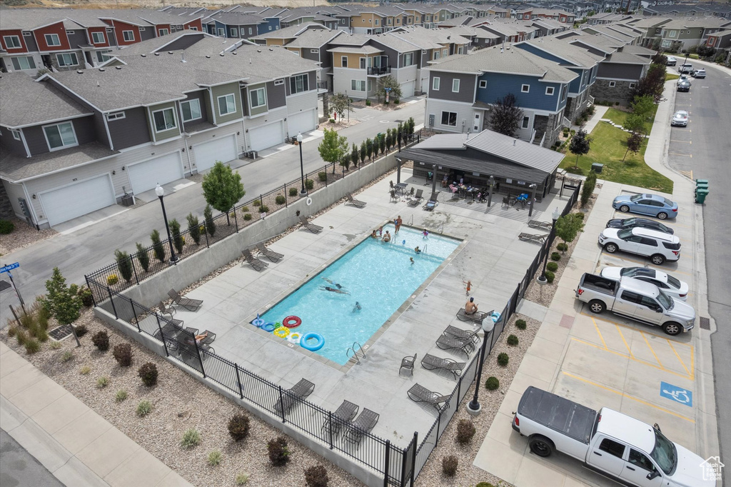 Aerial perspective of suburban area featuring a pool