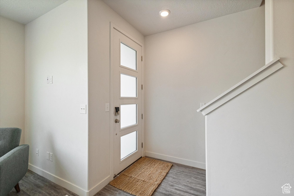 Foyer entrance with wood finished floors