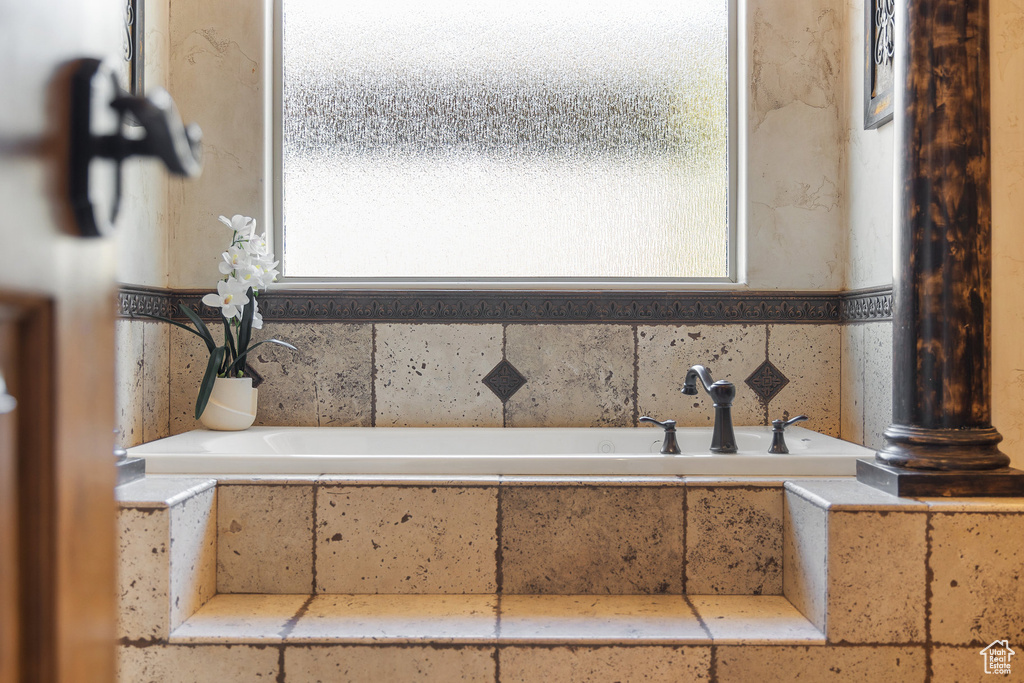 Bathroom with healthy amount of natural light and a garden tub
