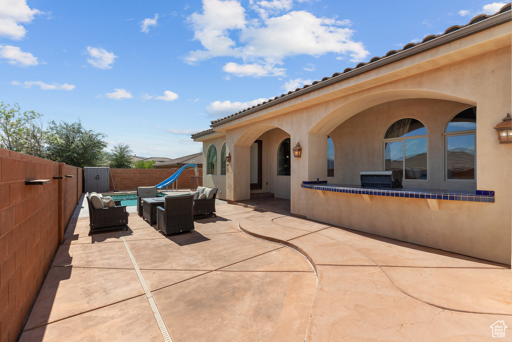 Fenced backyard with outdoor lounge area and a patio