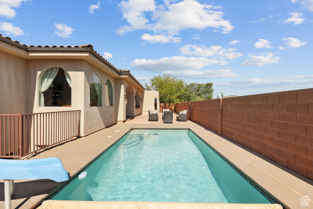 View of swimming pool with an outdoor hangout area, a fenced backyard, and a patio
