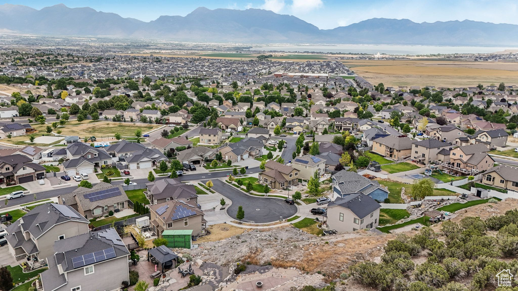 Aerial overview of property's location featuring mountains and nearby suburban area