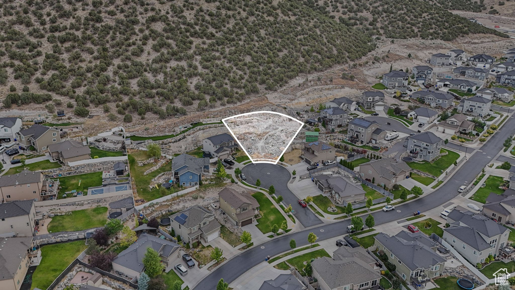 Aerial view of property and surrounding area featuring nearby suburban area
