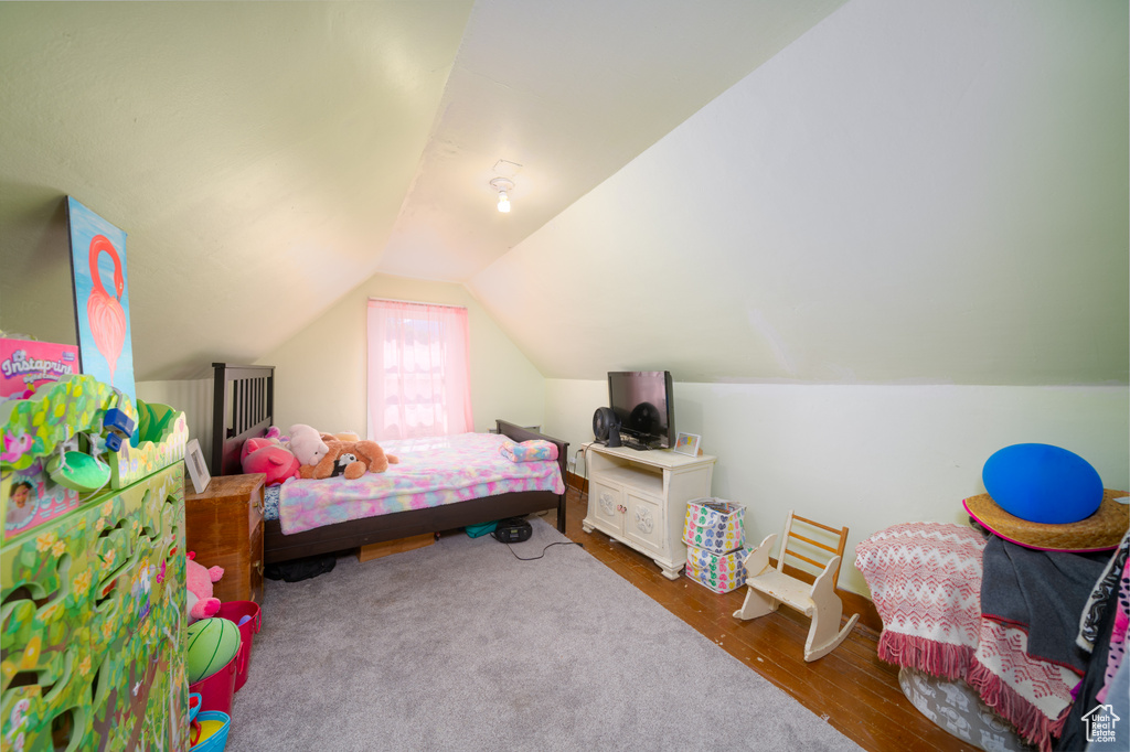 Bedroom featuring vaulted ceiling and wood finished floors