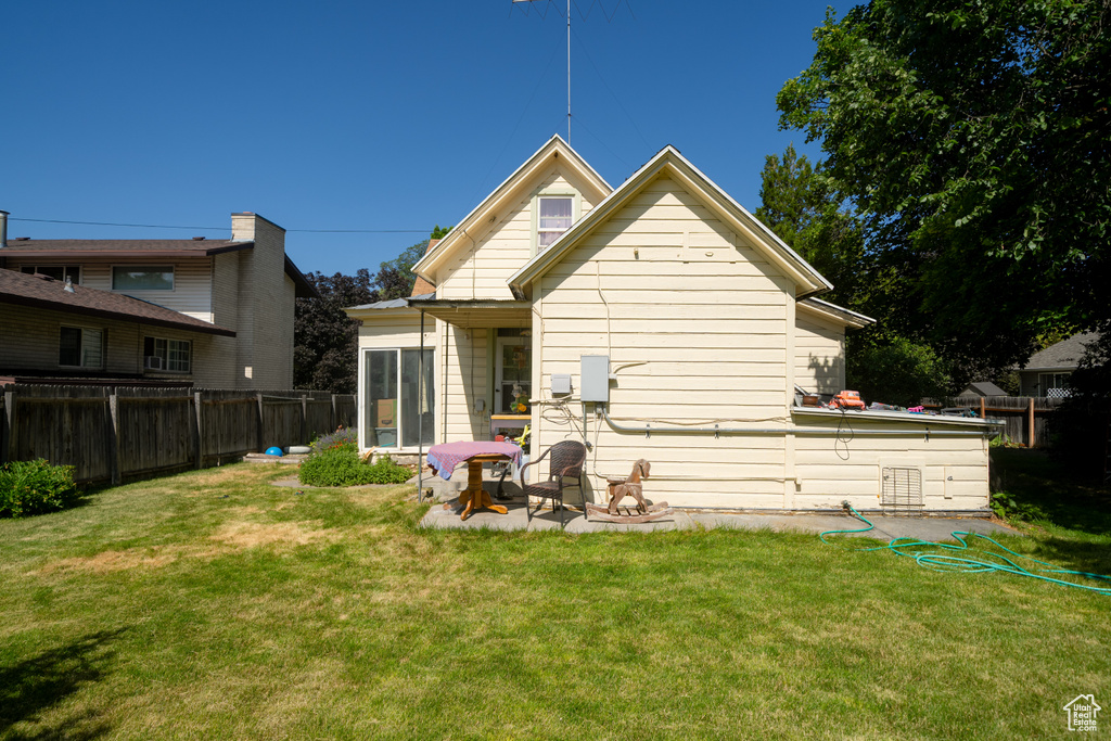 Rear view of property with a fenced backyard