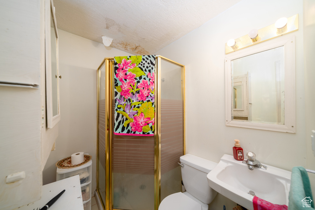 Full bathroom featuring toilet and a shower stall