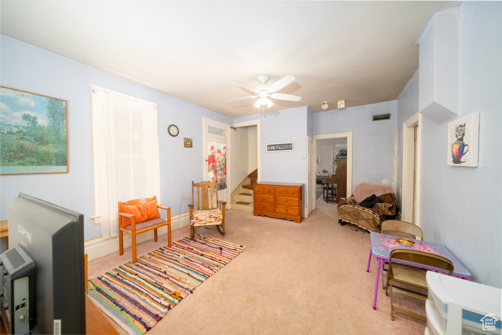 Sitting room with carpet floors and ceiling fan