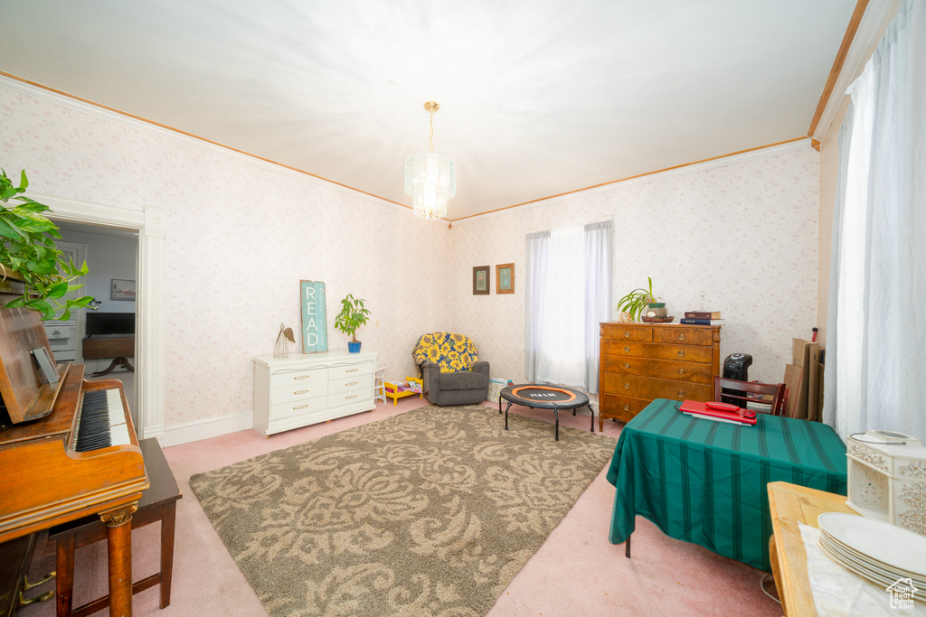 Bedroom with crown molding, wallpapered walls, carpet flooring, and a chandelier