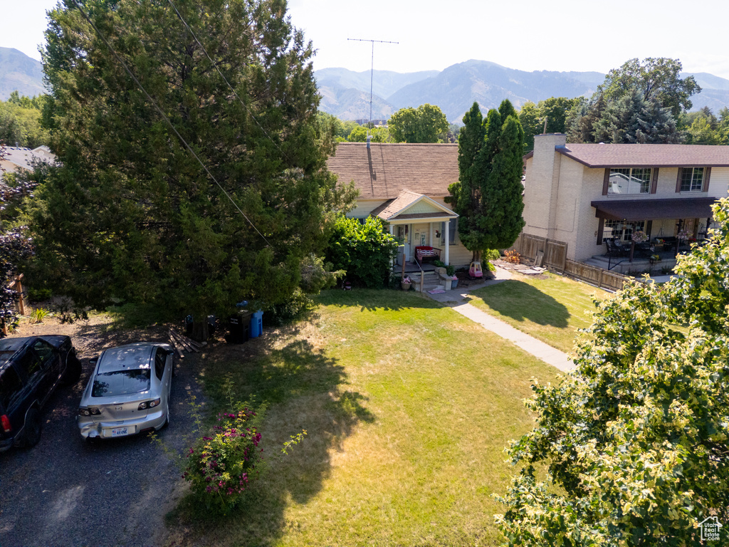 View of front of home featuring a mountain view and a front lawn