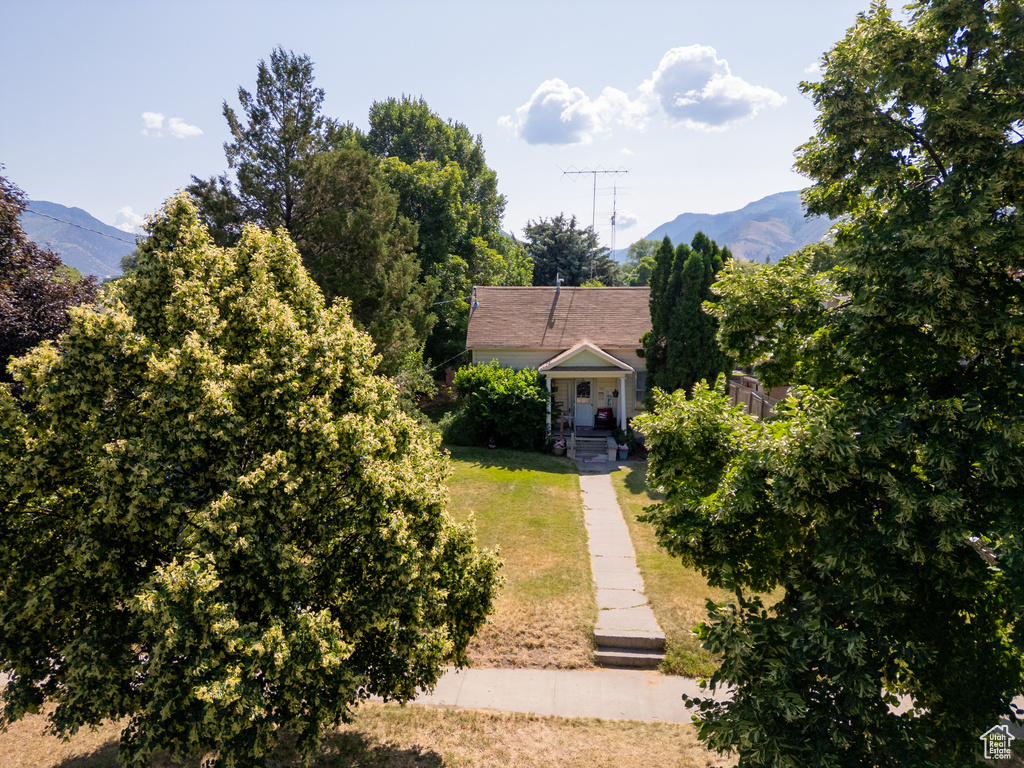 View of front facade featuring a mountain view and a front yard