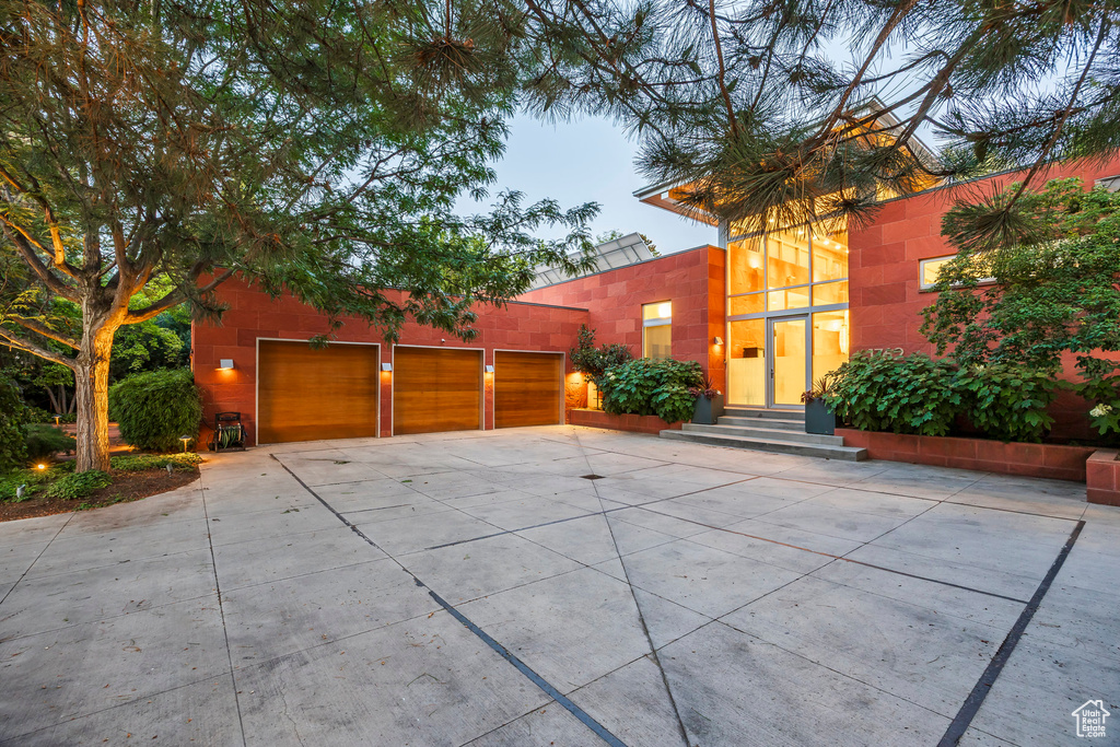 View of front of home featuring entry steps, concrete driveway, and a garage