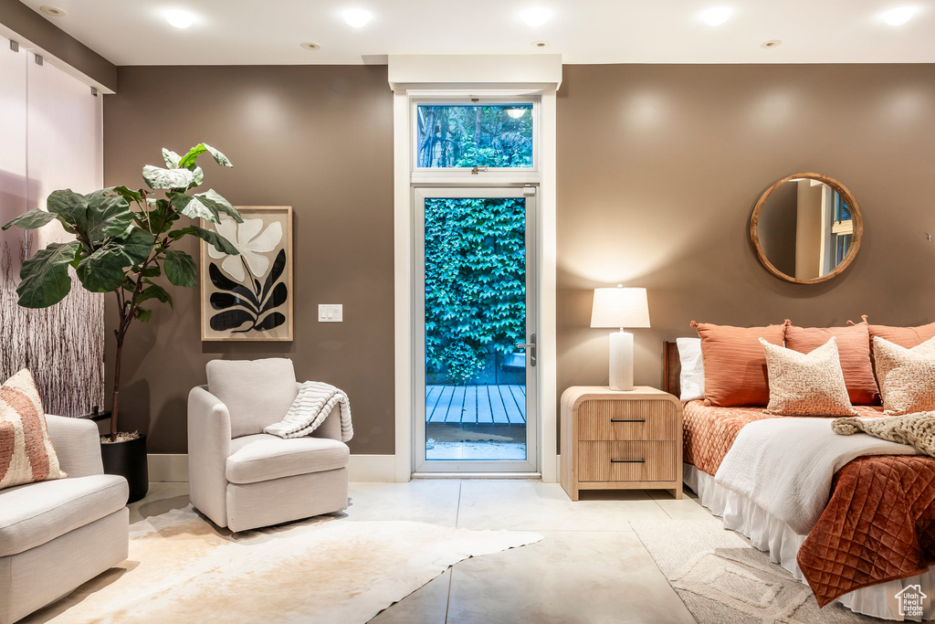 Bedroom featuring access to outside and finished concrete floors